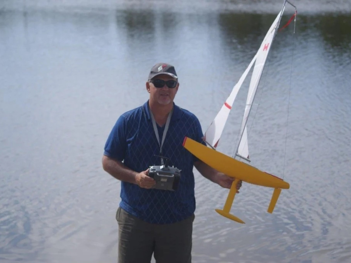 gary hirst carrying his model yacht