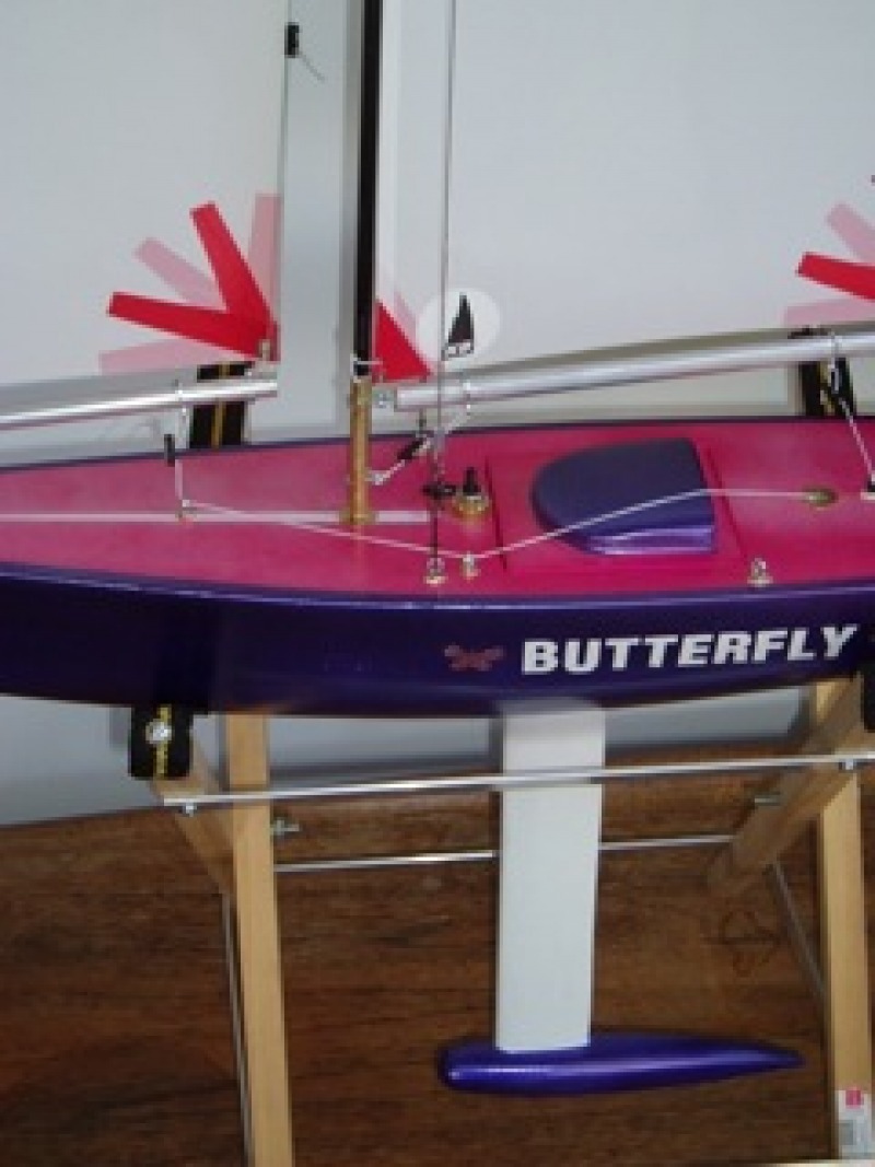 Jerome Declerck's model yacht pink and purple hull sitting in a cradle