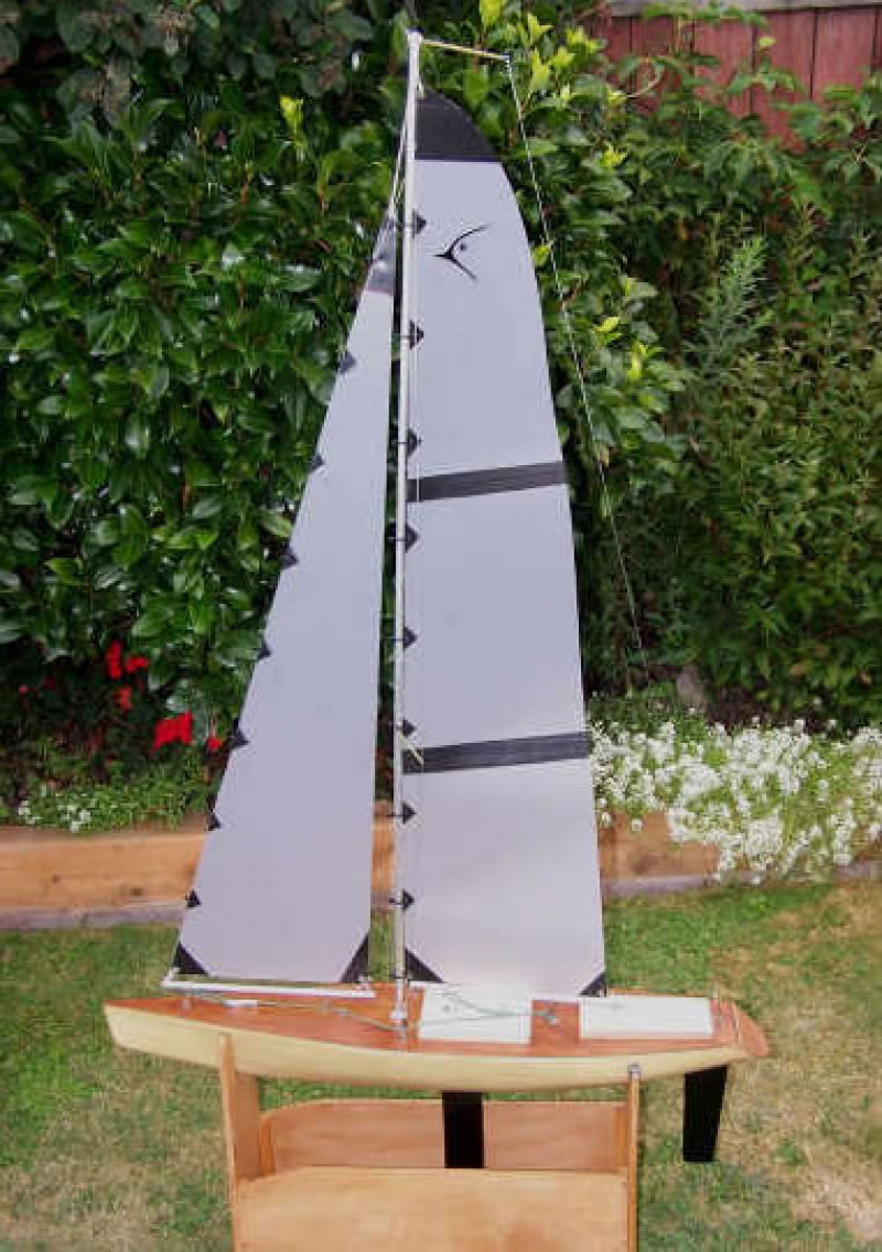 A cream coloured model yacht with a wooden deck sitting on a cradle, Location: Nelson, New Zealand