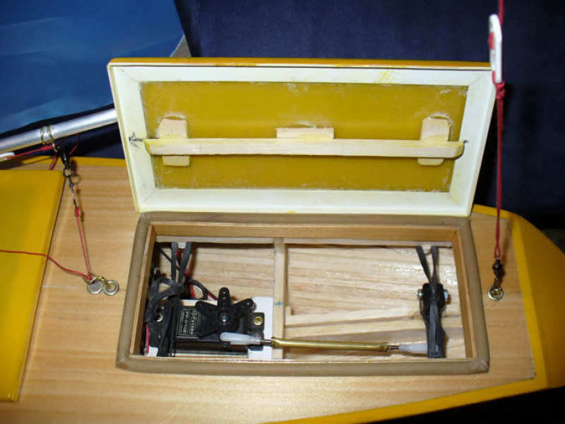 A yellow model yacht with the hatch open showing the internal workings and servos, Location: Christchurch, New Zealand