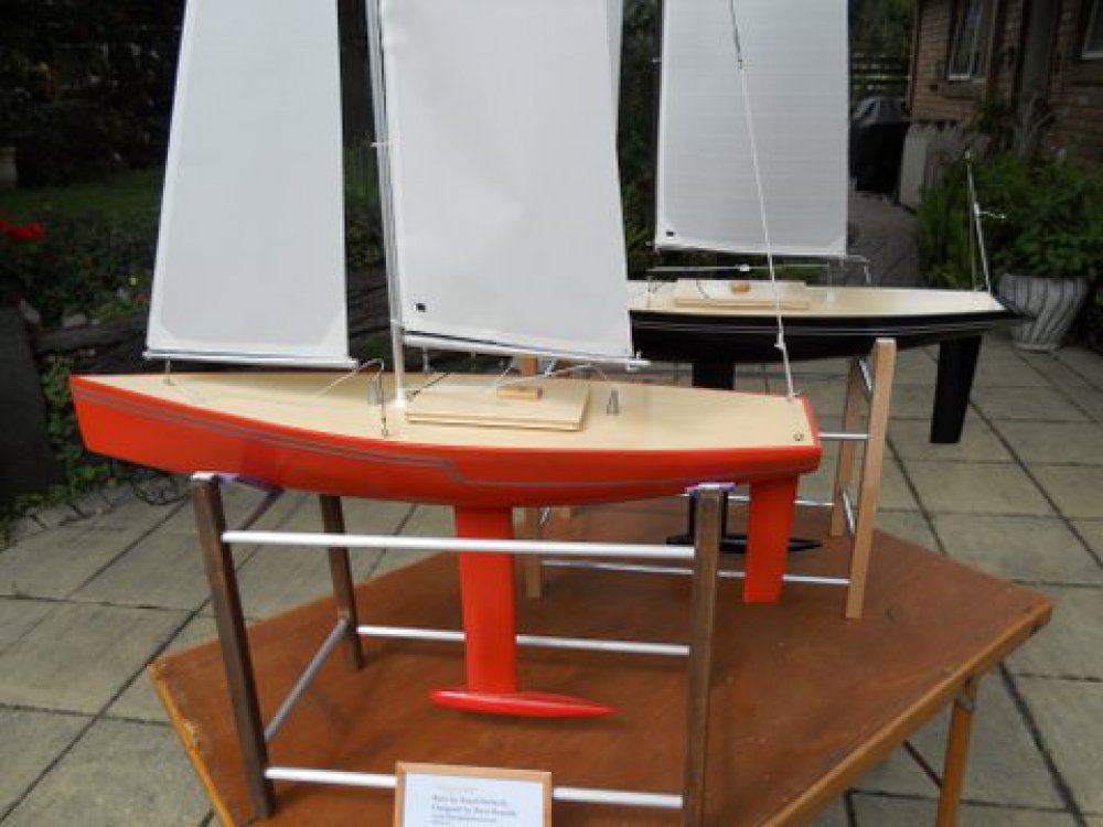 Racing Sparrow model yachts, orange rg65 and a black 750 in the background